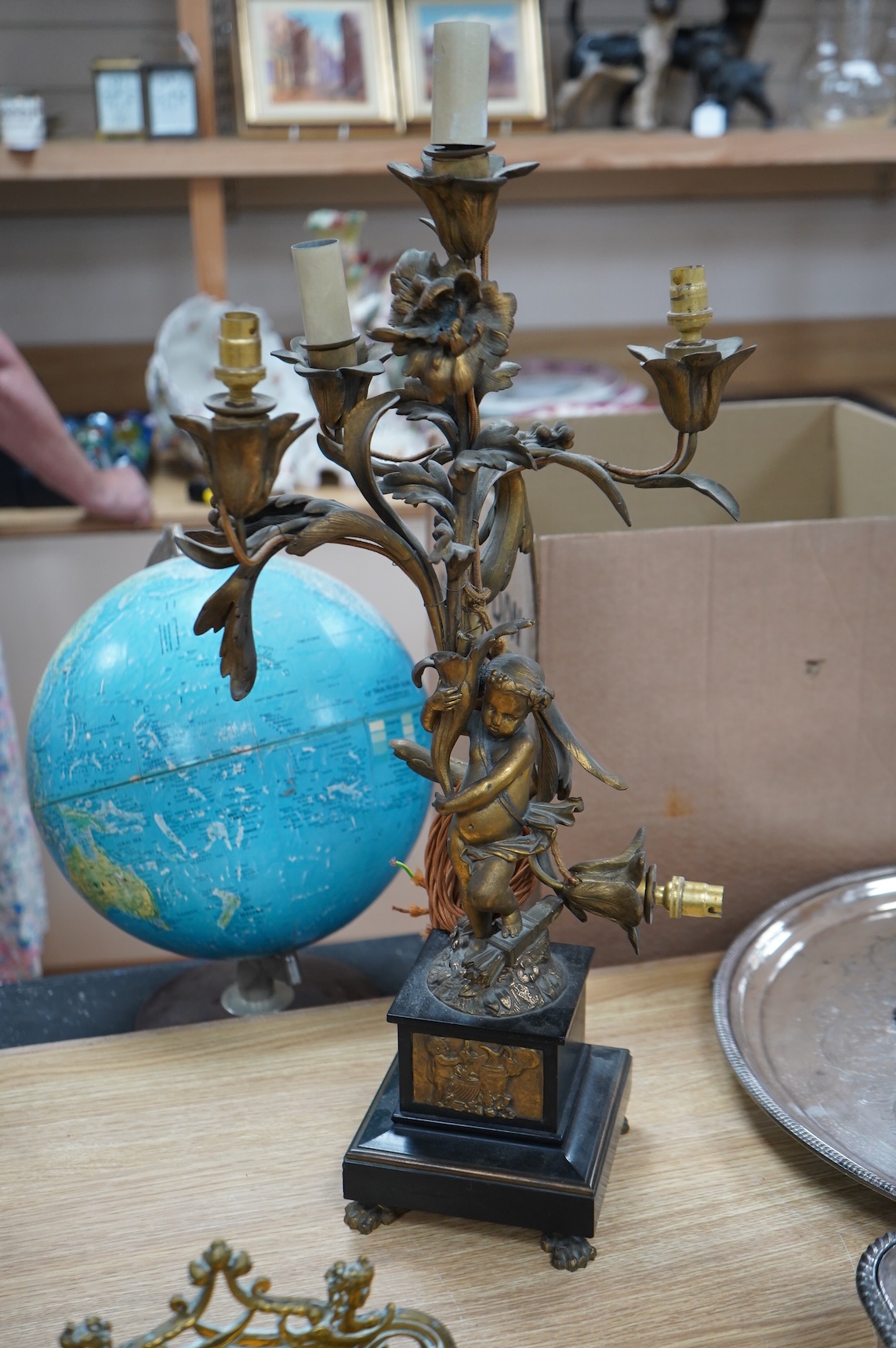 An early 20th century ormolu and marble ‘cherub’ converted candelabra and a brass desk stand, tallest 56cm